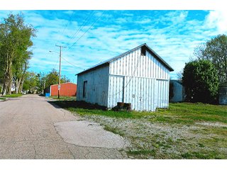 <b>TRACT #1 - GRAIN ELEVATOR</b>  (<b>SOLD - 9/9/16 $110,000</b>)
Note:  The grain bins, drier and legs are on R.R. leased property.  Mr. Voreis stated that lease payment is $900/year.

<b>Improvements - Grain Bins, Drier & Legs:</b>
1994     90,000 bu. bin with air tubes
1994     15,000 bu. hopper bin
               7,000 bu. bin
             42,000 bu. bin with air tube
<b>Drier:</b>  12'x45';1994 Zimmerman grain drier; S.S. 1,500 bu./hr. at 10 pts.;Natural gas
<b>Leg:</b>  1994 110' grain leg; 8,000 bu./hr.
<b>Drier Grain Leg:</b>  5,000 bu./hr.
<b>North Leg:</b>  7,000 bu./hr.
<b>Top Conveyor:</b>  1994 Chain Conveyor
<b>Bottom Conveyor:</b>  U-Trough Auger
<b>Dump Pit:</b>  Approx. 150 bu. with auger to leg

<b>Office:  Portable</b>  A 10' x 50' office with 2 separate offices, customer counter area, 1 restroom

<b>Grain Probe:</b>  A Hyd. Grain Probe

<b>Scales:</b>  10' x 60' Metal deck, scales, load cells, 100,000 lb. capacity, digital read-out and printer

<b>Quonset:</b>  A 41' x 120' metal Quonset building with concrete floor, top auger with 70,000 bu. capacity.

<b>Shop:</b>  A 22' x 40' wood frame with metal siding, concrete floor, heater

<b>Rail Siding:</b>  7+ Car rail siding along the east side of the grain bins.

<b>Utilities:</b>  City - Water and sewer; Electric - 480 (4) phase; Gas - Nipsco 

<FONT FACE="Arial, Helvetica, sans-serif" size="2" color="#0000FF"><b>TRACT #2 - STORAGE WAREHOUSE</b> (<b>STILL AVAILABLE</b>)

<b>2 Lots, Improvements</b>  60' x 112' wood frame structure, concrete floors, 4 doors, dock high load-out.</font face>



 - Grain Elevator (SOLD - 9/9/16) Storage Warehouse Still Available